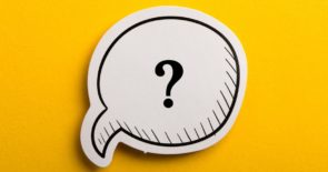 Question mark drawn on a speech bubble against a yellow background.